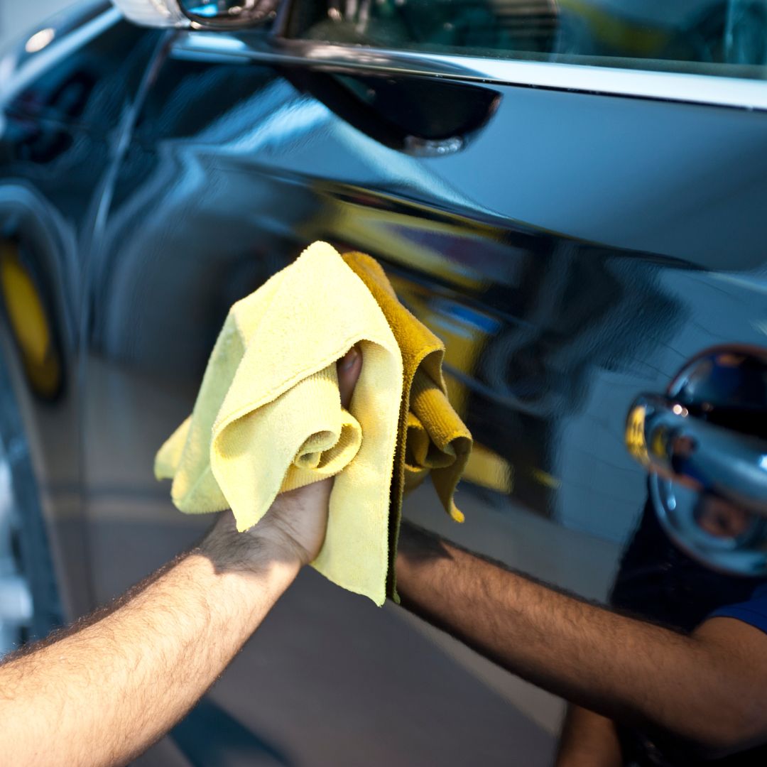 wiping car with microfiber
